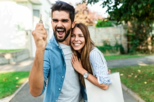 Happy couple holding up new house keys